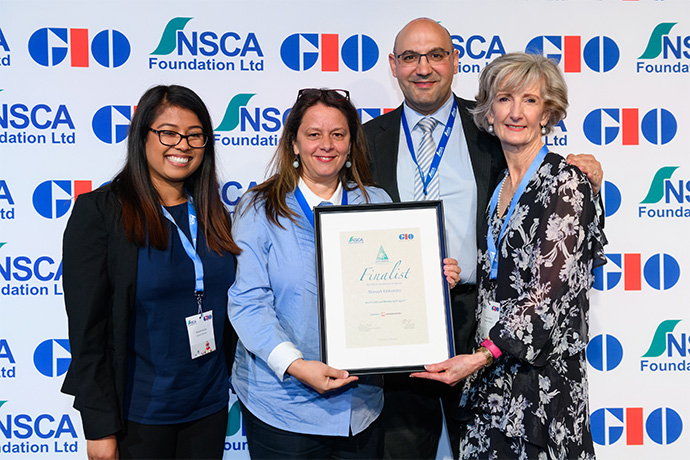Photo of Monash University receiving their award from Safe Work Australia Director, Frank Cachia.