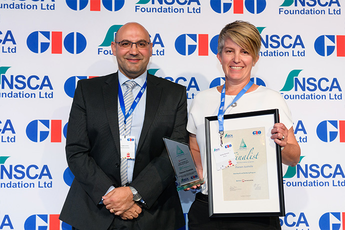Photo of Pearson Australia receiving their award from Safe Work Australia Director, Frank Cachia.