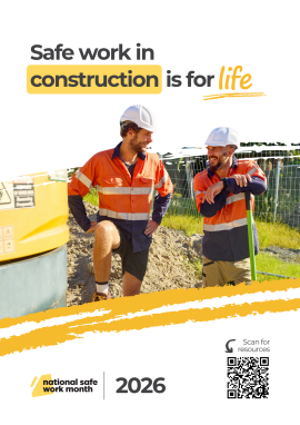 Construction site scene showing two workers in high-visibility clothing and hard hats talking while standing beside excavation equipment with the text “Safe work in construction is for life”.