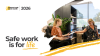 Image shows an office-based environment with a woman in a wheelchair handing a document to another woman seated at a desk. Text reads: National Safe Work Month 2026 - Safe work is for life